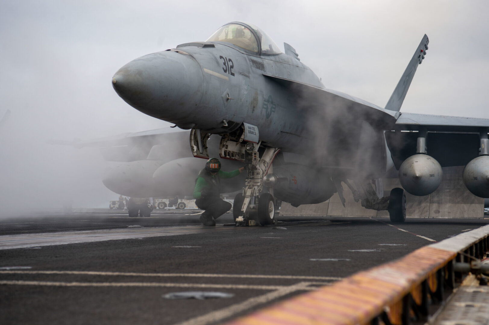 PACIFIC OCEAN (Oct. 14, 2022) A sailor gives the sign for an F/A-18E Super Hornet, from the ÒKestrelsÓ of Strike Fighter Squadron (VFA) 137, to taxi onto the catapult on the aircraft carrier USS Nimitz (CVN 68). Nimitz Strike Group is underway preparing for an upcoming deployment. (U.S. Navy photo by Mass Communication Specialist 2nd Class Justin McTaggart)