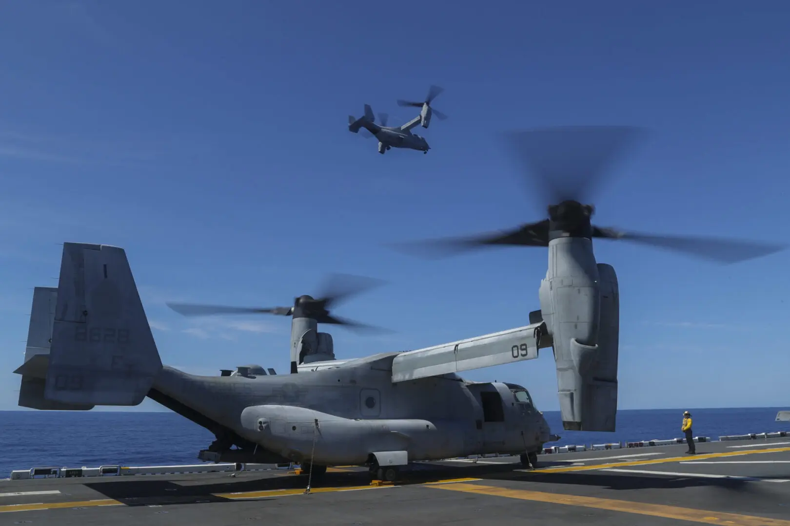 SOUTH CHINA SEA (Oct. 8, 2022) An MV-22 Osprey tiltrotor aircraft assigned to Marine Medium Tiltrotor Squadron (VMM) 262 (Reinforced) flies over the amphibious assault ship USS Tripoli (LHA 7) Oct. 8, 2022. Tripoli is operating in the U.S. 7th Fleet area of operations to enhance interoperability with allies and partners and serve as a ready response force to defend peace and maintain stability in the Indo-Pacific region. (U.S. Navy photo by Mass Communication Specialist 2nd Class Malcolm Kelley)